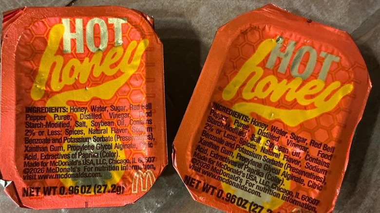 Two containers of McDonald's Hot Honey sauce