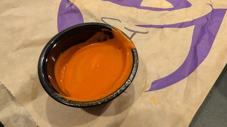 A container of Taco Bell Caliente Cantina Sauce