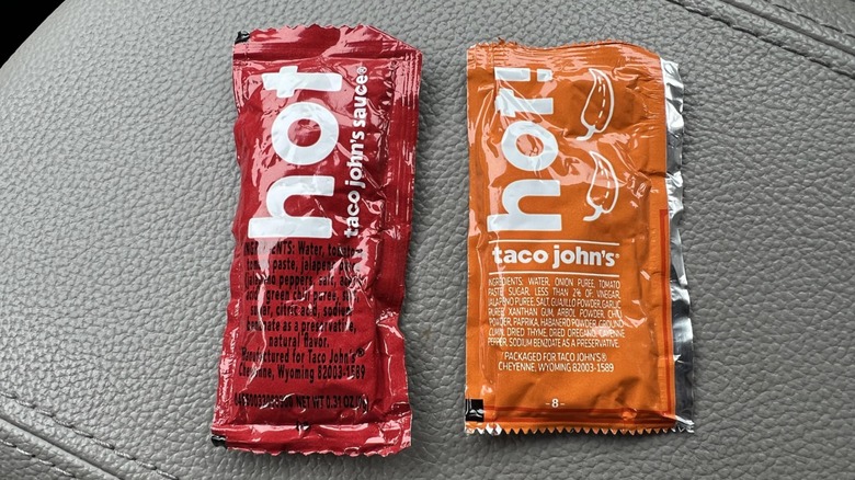 Two packets of Taco John's hot sauce