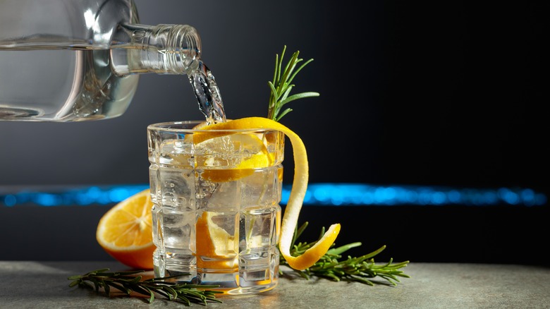 Bottle of gin being poured into glass