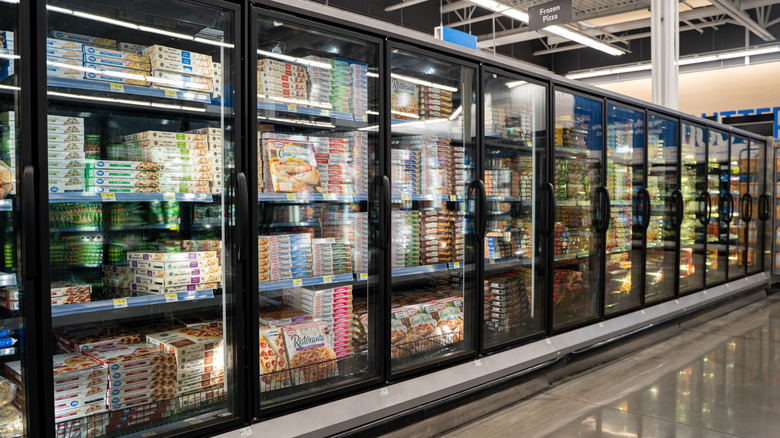 The frozen pizza aisle at a grocery store.