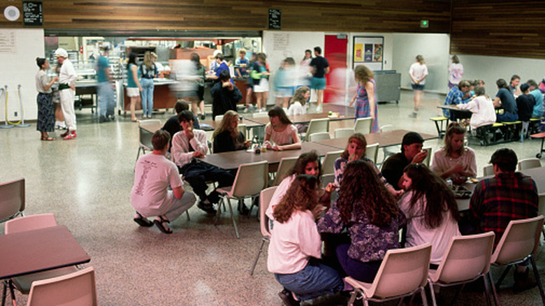 Students in a 1990s-style cafeteria