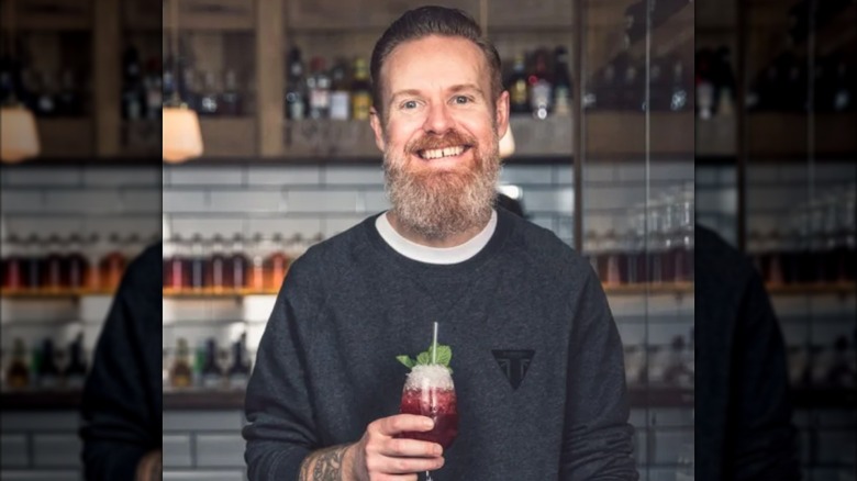 Jason Scott holding a cocktail
