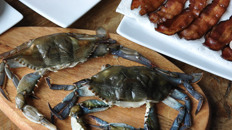 raw soft-shell crabs sitting on cutting board