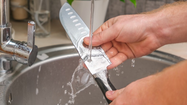 rinsing knife in sink