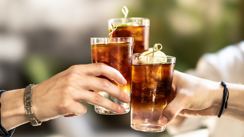 Friends toasting espresso soda mocktails.