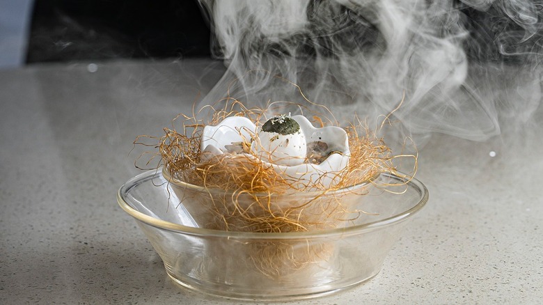 A smoking egg dish at Le Chique in Cancun