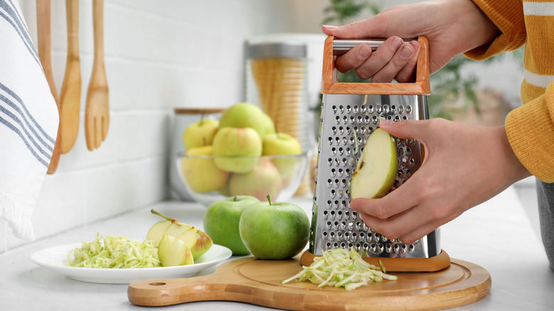 woman grating an apple