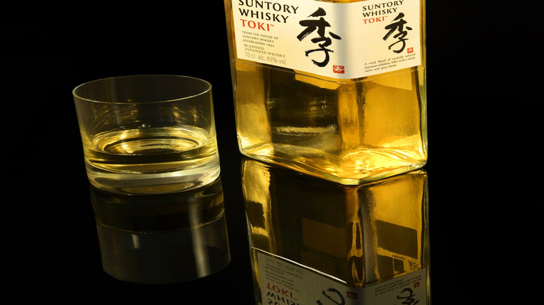 Bottle of Toki whisky with glass