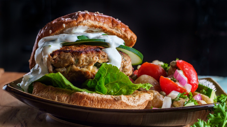 a turkey burger with greek-inspired toppings