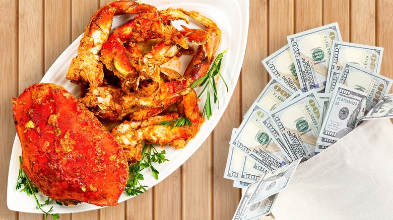 Plate of expensive crab and dollar bills on table.