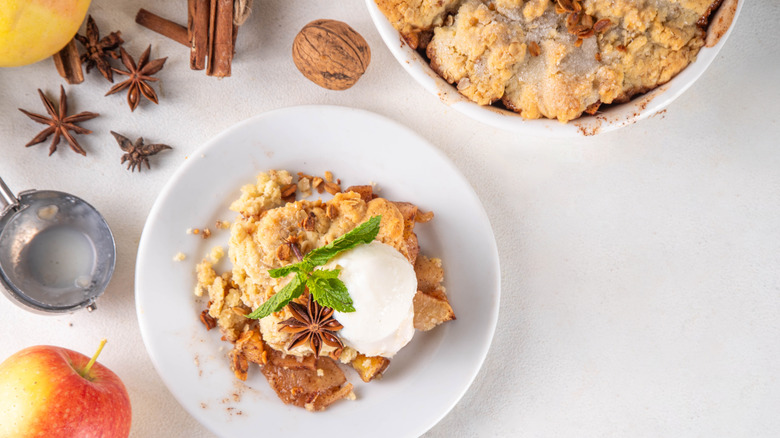 overhead view of apple cobbler in a bowl with ice cream