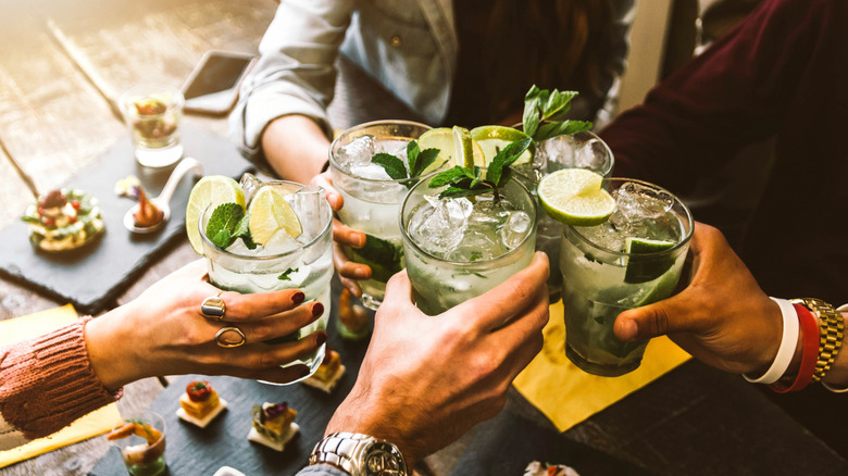 group clinking cocktails together