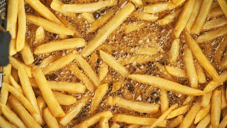 French fries frying in hot, bubbling oil