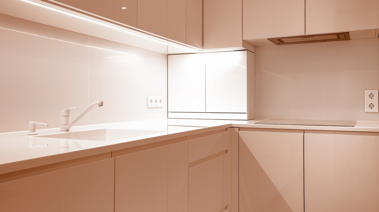 A clean and empty kitchen with sleek cabinets and countertops