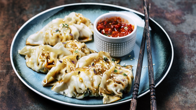 plate of dumplings with a spicy sauce