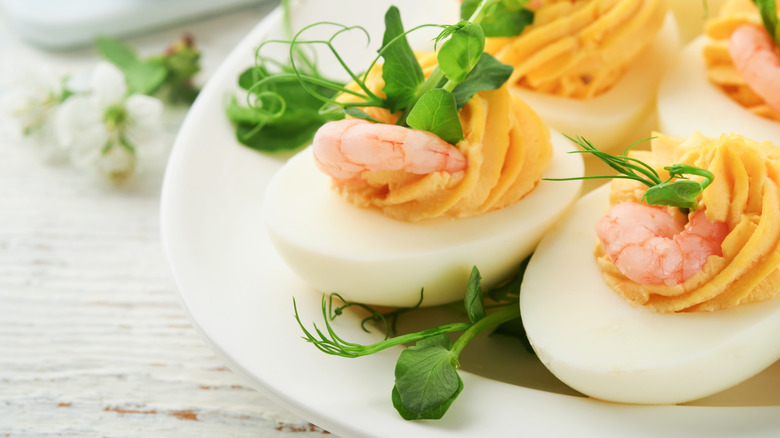 close-up deviled egg with fresh herbs