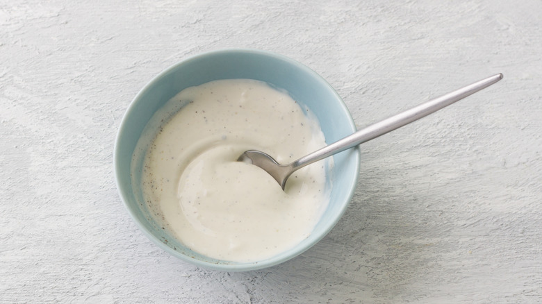 Caesar dressing dip in a bowl with a spoon