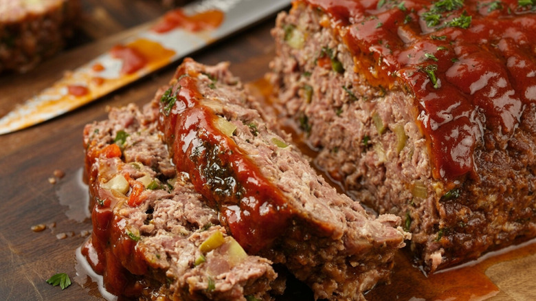 Sliced meatloaf on a wood cutting board