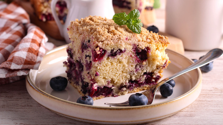 Slice of blueberry buckle on a plate.