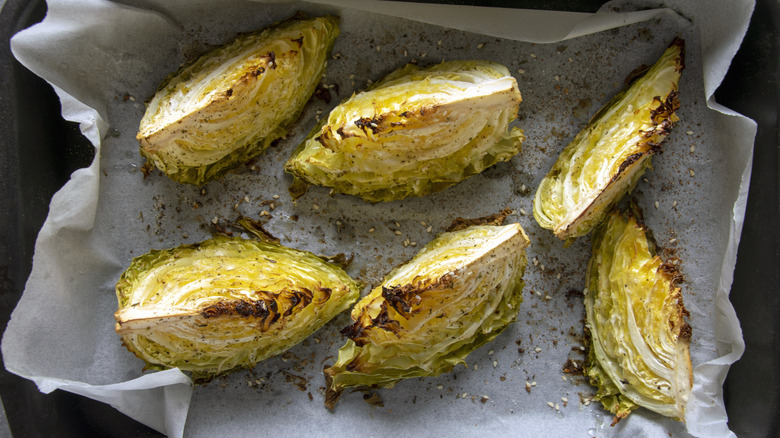 Cabbage wedges in a roasting pan.