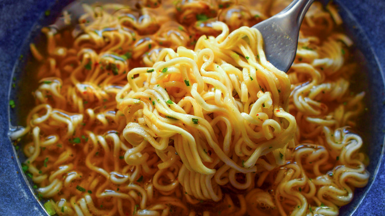 Instant noodles on fork in a bowl