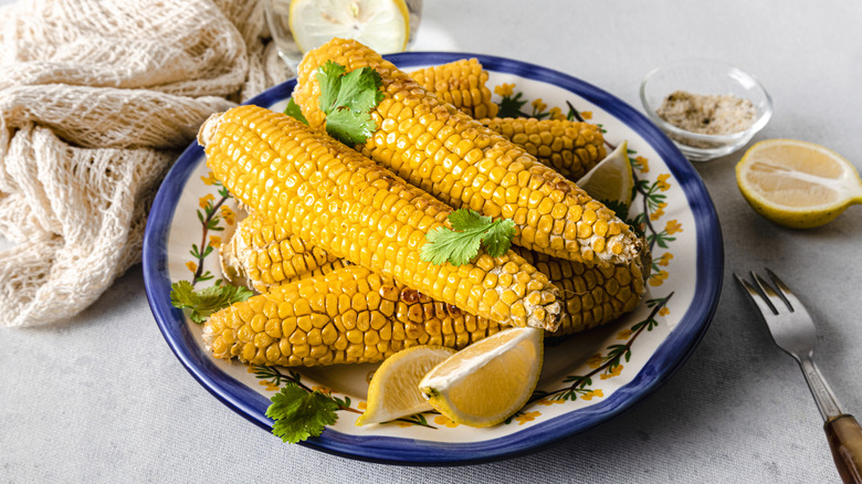 Boiled corn on the cob on a floral plate
