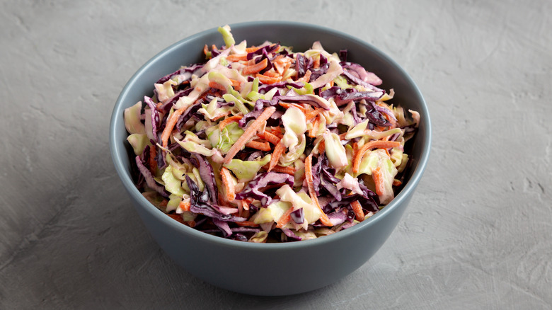 bowl of coleslaw on neutral background