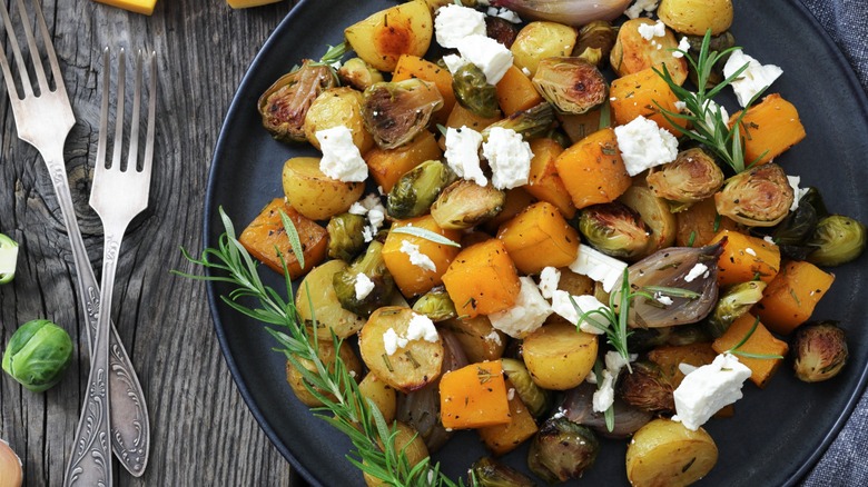 Plate of Brussels sprouts and goat cheese with squash