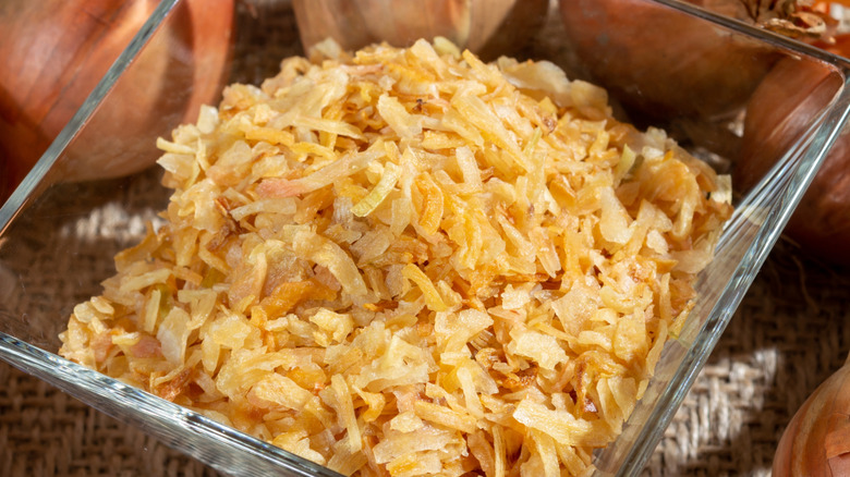 close-up of dried onion flakes against whole onions