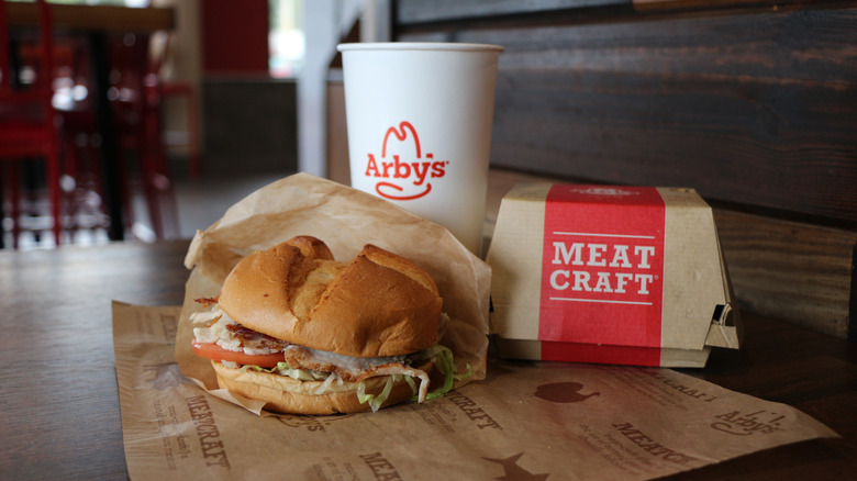 Arby's sandwich, drink, and box on a table