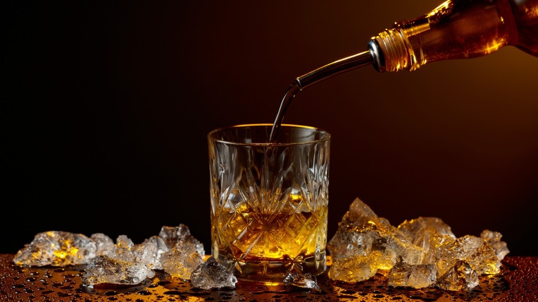 Pouring whiskey into a glass