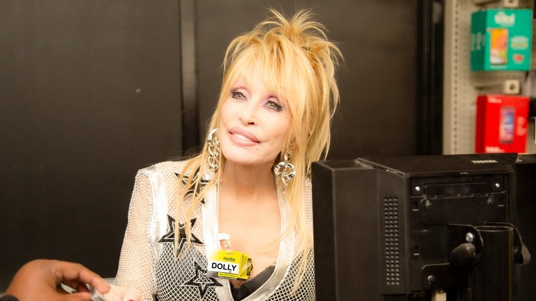 Dolly Parton doing a public appearance working the cash register at Dollar General