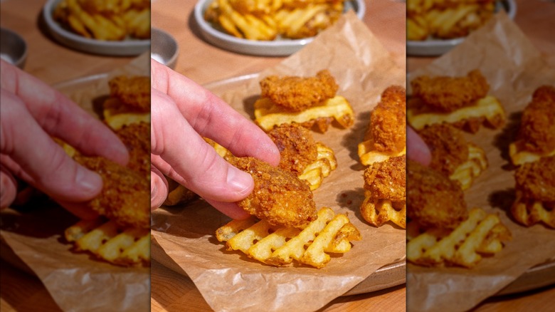 Chicken nuggets on top of Grown in Idaho super crispy waffle french fries on table.