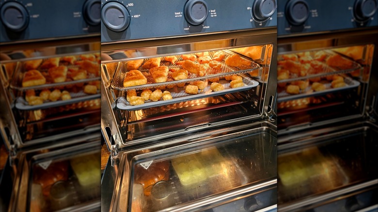 Our Place Wonder Oven Pro in color blue salt with food cooking inside.