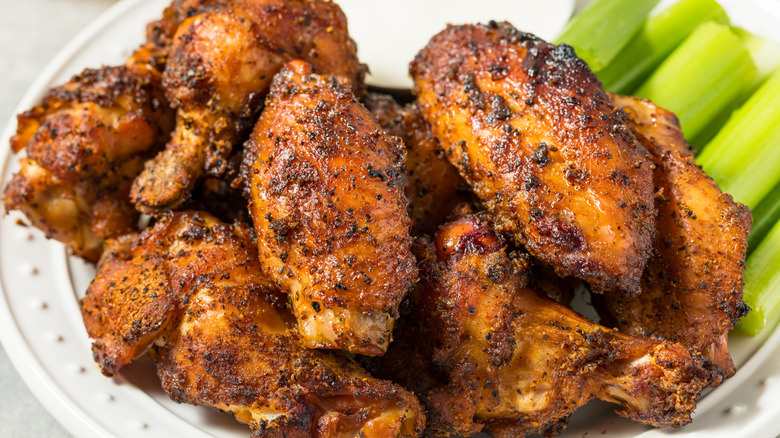 crispy chicken wings on a plate with buffalo sauce