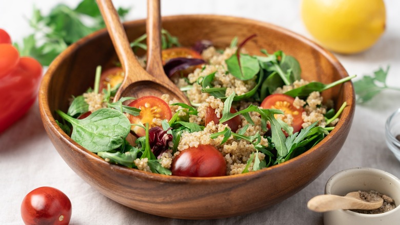 A wooden salad bowl sitting on a table