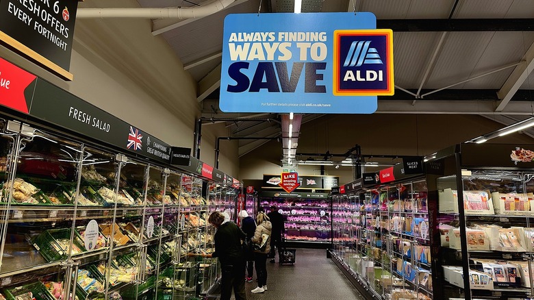Customers shopping in the refrigerated section of an Aldi store in Great Britain.