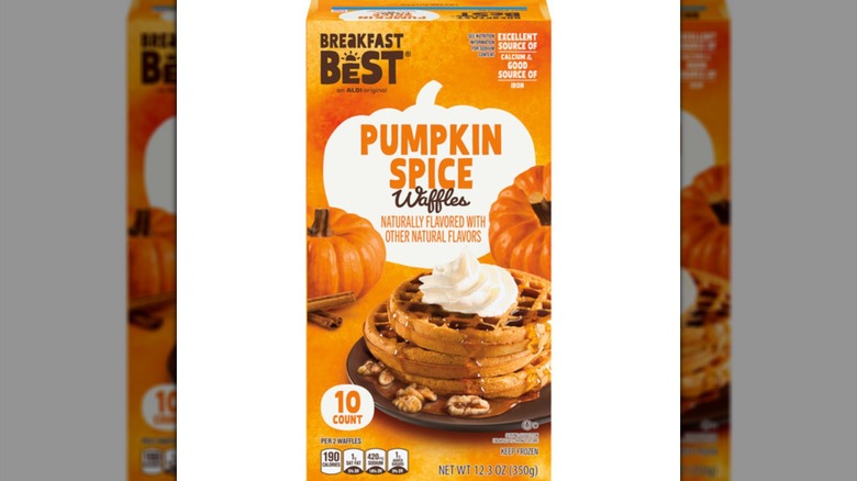 An orange box of pumpkin spice waffles, showing an image of the product drizzled in syrup and topped with whipped cream.