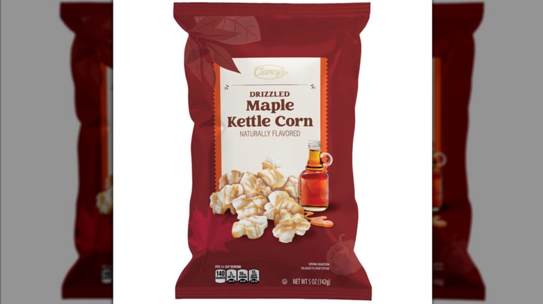 A bag of maple kettle corn, with an enlarged image of a popcorn and a jar of maple syrup beside it.