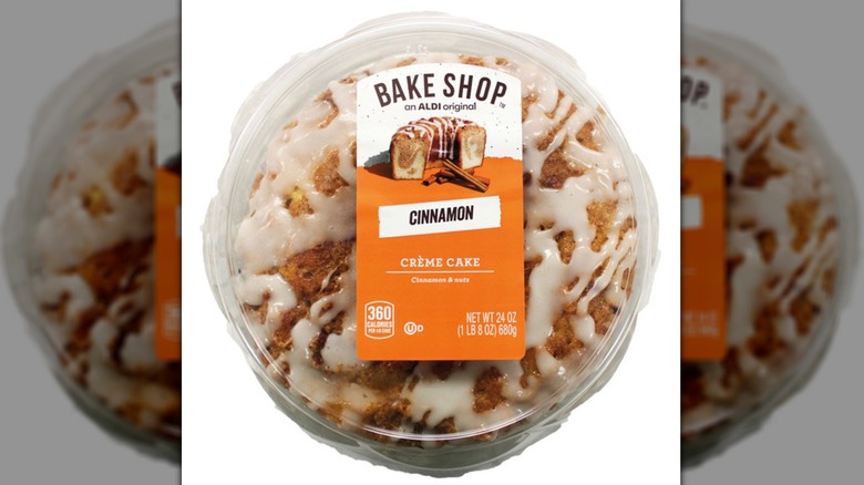 Plastic clamshell package containing a round Bake Shop Cinnamon Crème Cake
