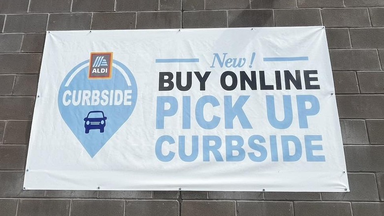 A sign hangs outside  of an Aldi grocery store
