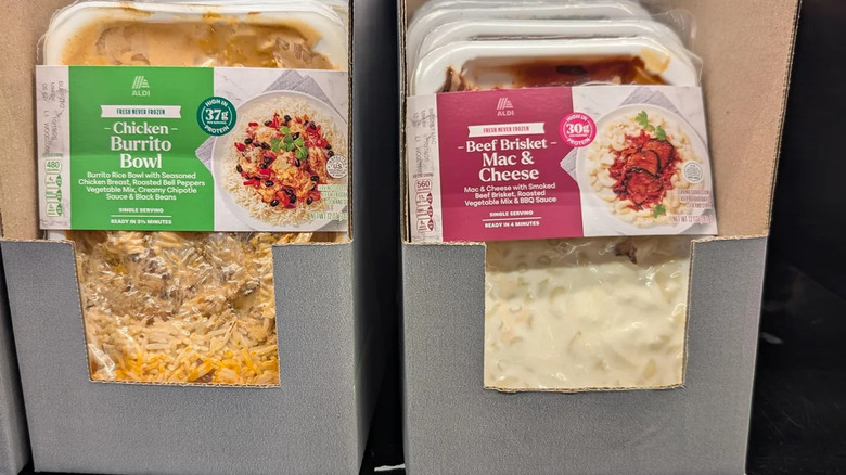 The Chicken Burrito Bowl and Beef Brisket Mac & Cheese ready made meals on a store shelf at Aldi
