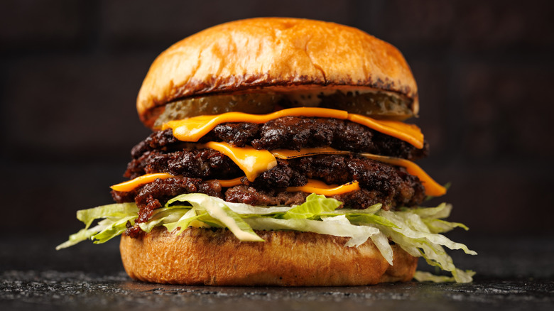 a triple-stacked smash burger with crispy, thin patties