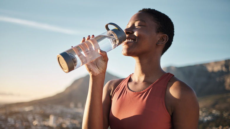 Woman drinking from water bottle