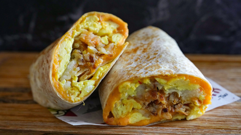 Breakfast burrito with meat and cheese on counter