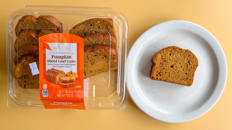 Pumpkin loaf cake in a clamshell with a plate
