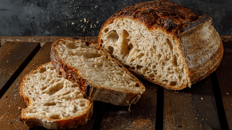 A loaf of sourdough bread on a wooden board