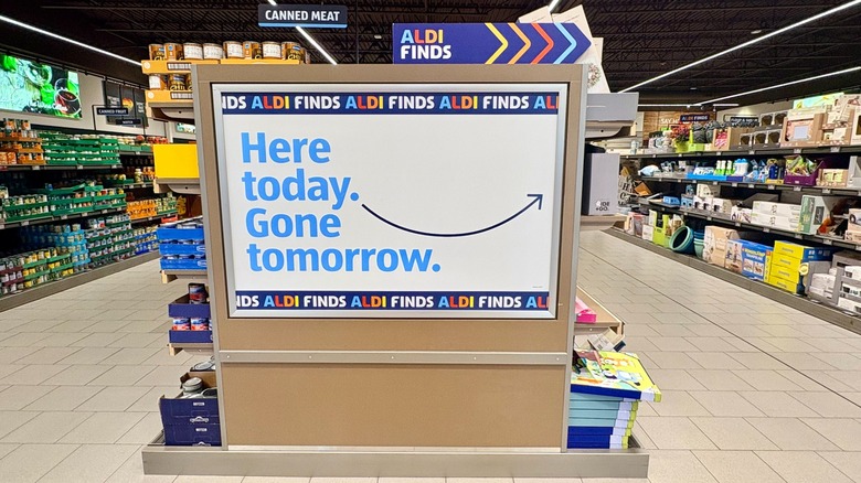 A man pushing a shopping cart while perusing the Aldi Finds aisle in store