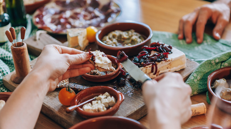 Person eating from a snacking board